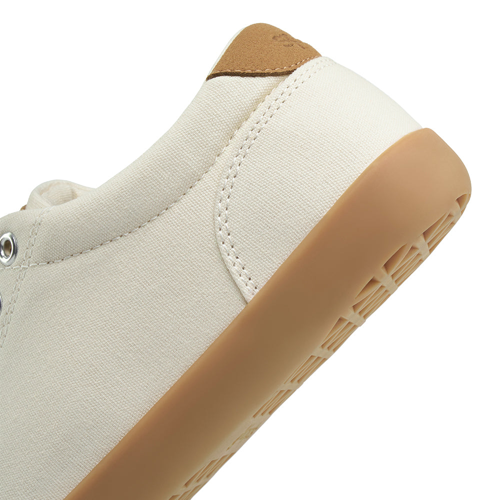Close-up showing detail of the heel for a light tan FREESTYLE 3 sneaker with brown gumsole on a white background