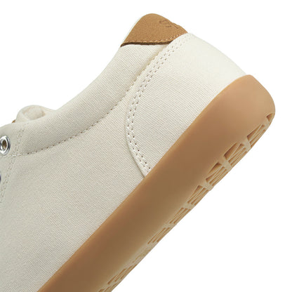 Close-up showing detail of the heel for a light tan FREESTYLE 3 sneaker with brown gumsole on a white background