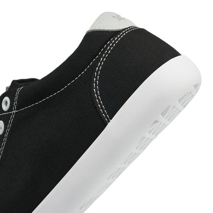 Close up view of the back half of the FREESTYLE 3 Coal, Black sneaker with white eyelets and light grey accents on a white background