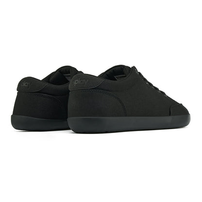 Back angle view of the FREESTYLE 3 Jet, Black sneaker with black laces, and black outsole on a white background. Shows details of the heel label and back panel of the shoe. 