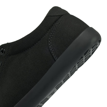 Close up view of the back half of the FREESTYLE 3 Jet, Black sneaker with black eyelets and black accents on a white background