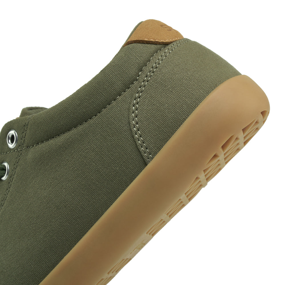 Close up view of the back half of the FREESTYLE 3 Pine, Pine green sneaker with metallic eyelets and brown accents on a white background