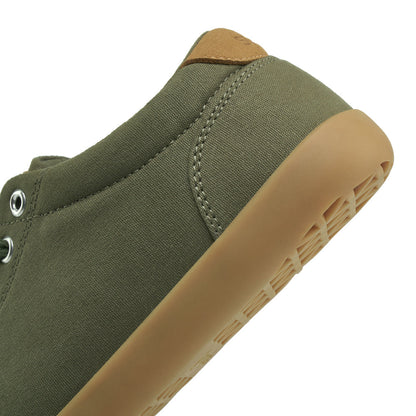 Close up view of the back half of the FREESTYLE 3 Pine, Pine green sneaker with metallic eyelets and brown accents on a white background
