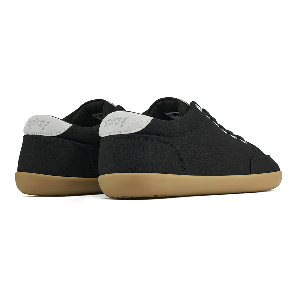 Back angle view of the FREESTYLE 3 Shale, black sneaker with black laces, and brown gumsole on a white background. Shows details of the heel label and back panel of the shoe. 