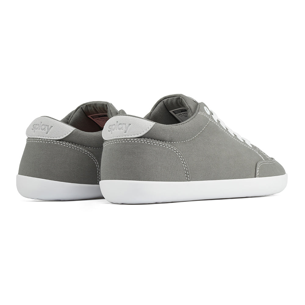 Back angle view of the FREESTYLE 3 Stone, grey sneaker with white laces, and white outsole on a white background. Shows details of the heel label and back panel of the shoe. 