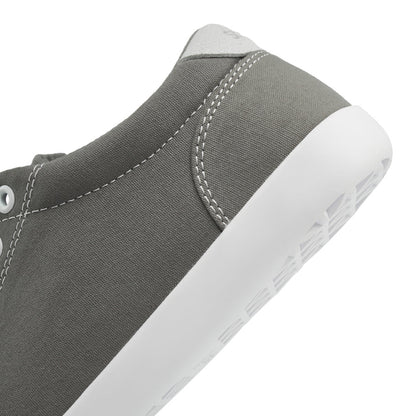 Close up view of the back half of the FREESTYLE 3 Stone, grey sneaker with white eyelets and light grey accents on a white background