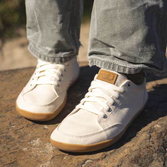 Close up picture of the FREESTYLE 3 Almond with a man standing on a rock. Light tan sneakers with brown gumsoles.