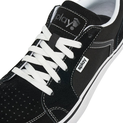 Close-up of the lace area of a black REV LTS Los Angeles sneaker showing contrast white stitching, laces, and tongue label with REV logo.
